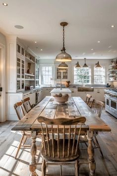 a wooden table sitting in the middle of a kitchen