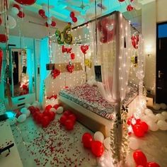 a bedroom decorated with balloons and streamers for valentine's day party decorating