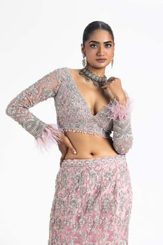 Make a statement in our pink net fishtailed lehenga set. This set features a long-sleeved choli and dupatta intricately embroidered with silver zari, dabka, sequins, and crystals. Perfect for adding a touch of elegance to your special occasions. Glamorous Fitted Anarkali Set With Intricate Embroidery, Glamorous Sets With Intricate Embroidery For Diwali, Fitted Pink Anarkali Set Hand Embellished, Fitted Pink Hand Embellished Anarkali Set, Party Wear Long Sleeve Sharara With Sequins, Long Sleeve Sharara With Sequins For Party Wear, Glamorous Fitted Anarkali Set With Resham Embroidery, Party Wear Sharara With Sequins And Long Sleeves, Party Wear Sharara With Sequins