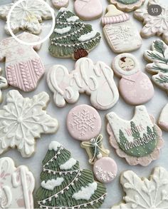 decorated christmas cookies are displayed on a table