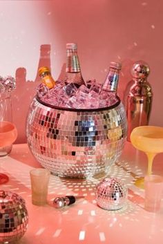 a disco ball filled with lots of different types of bottles and glasses on top of a table