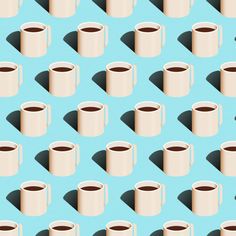 several coffee mugs are arranged on a blue background with long shadows from the cups