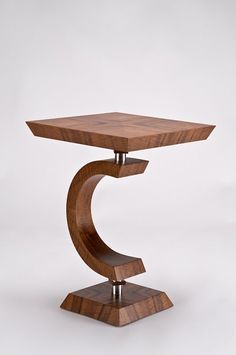 a wooden table with a metal base on it's legs and an upside down design