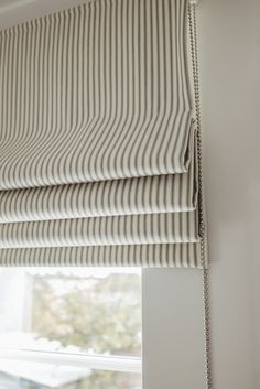 a close up of a roman blind in a window