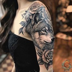 a woman with a wolf and roses tattoo on her arm