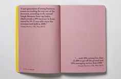 an open pink book with black lettering on it