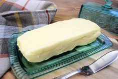 a piece of butter sitting on top of a green plate