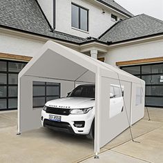 a white car is parked in front of a house with an awning on it