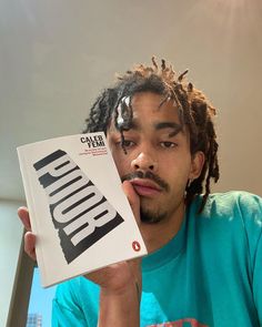 a man with dreadlocks reading a book