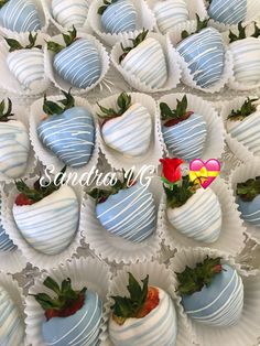 there are many chocolate covered strawberries in the trays with strawberry decorations on them