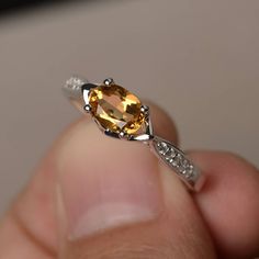 This is a gorgeous handmade creation. Its beauty is its simplicity & Elegance. The 5*7 mm oval shape faceted natural citrine is crafted in solid sterling silver and with rhodium plated. All item is sent in a beautiful gift box If you have any idea of design your ring,pls contact me directly. You can realize more lovely stuff clicking the link https://www.etsy.com/shop/knightjewelry?refshopsection_shophome_leftnav Please leave the correct address and you phone number for delivering successful Amber Birthstone Ring, Oval Citrine Birthstone Ring, Oval Yellow Citrine Birthstone Ring, Oval Amber Topaz Ring, Oval Citrine Birthstone Ring For Anniversary, Oval Faceted Birthstone Ring For Anniversary, Oval Citrine Topaz Ring In White Gold, Oval Citrine Promise Ring, Oval Citrine Crystal Ring With Birthstone