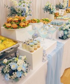 there are many desserts on the table at this wedding reception, including cupcakes and flowers