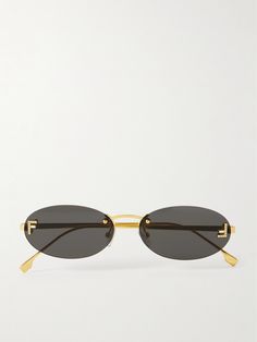 FENDI Eyewear's sunglasses have a rimless oval-frame shape inspired by those popular in the '90s and early aughts. They're made from gold-tone metal and feature tiny crystal-embellished 'F' emblems at the temples. Fendi Glasses Sunglasses, 2025 Sunglasses, Fendi Sunglasses Women, 90s Sunglasses Vintage, Oval Sunglasses 90s, Expensive Wishlist, Sunglasses Fendi, Fendi Glasses, Fendi Eyewear