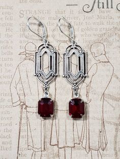 These Deco dangles are the perfect earrings for a 1920s themed wedding or party. Red vintage glass beads dangle from silver plated brass Art Deco style connectors. The silver plated brass stampings have an ornate front and a reverse side that is slightly hollow. (SEE 2nd PHOTO) These earrings are lightweight (lobe friendly) yet sturdy, free of lead and nickel. The earrings measure 2 1/4 inches long from the top of the ear wires to the bottom of the glass beads. They hang from silver plated lever Classic Handmade Earrings For Party, Vintage Formal Filigree Chandelier Earrings, Vintage Red Earrings For Party, Formal Vintage Chandelier Earrings, Art Deco Dangle Earrings For Vintage Events, Red Art Deco Jewelry For Wedding, Antique Nickel-free Earrings For Party, Victorian Dangle Earrings For Party, Victorian Dangle Chandelier Earrings For Parties