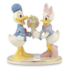 two figurines are holding hands with each other