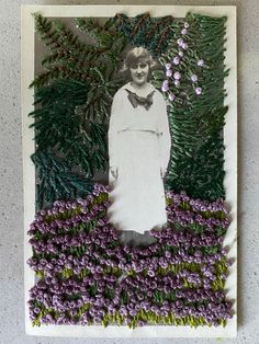 an altered photograph of a woman in white dress surrounded by purple flowers and pine needles