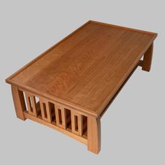 a wooden coffee table sitting on top of a gray floor with no one around it