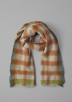 an orange and green plaid scarf on a gray background