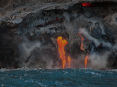 lava flowing out of the ocean into the water