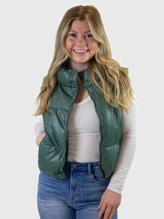 This puffer vest is perfect for fall, with a relaxed fit and effortlessly chic silhouette. It has a stand collar, and features a snap button closure with zipper. Side pockets are just right for carrying your phone or keys. The buttery soft fabric makes it easy to wear all season long. Trendy Fall Puffer Vest, Trendy Puffer Vest For Fall, Trendy Green Vest For Fall, Trendy Green Vest Outerwear, Trendy Everyday Fall Vest, Trendy Winter Vest With Button Closure, Everyday Fall Vest With Button Closure, Trendy Fall Vest With Zipper Closure, Trendy Winter Vest For Everyday Wear