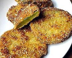 some fried food on a white plate with sesame sprinkles and seasoning