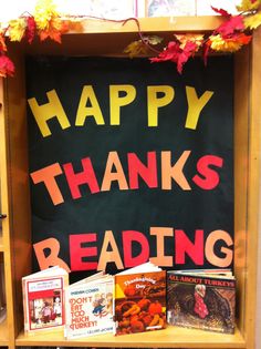 there is a sign that says happy thanks reading with books on the shelf in front of it