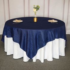 a round table with blue and white linen on it