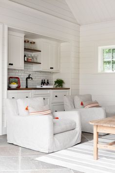 a living room filled with furniture and white walls