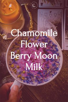 the cover of chamomile flower berry moon milk is shown in front of a candle