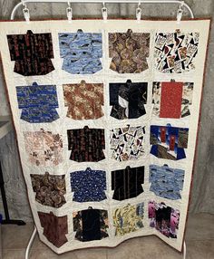 a quilt is hanging up on a rack