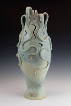 a white vase with wavy designs on it