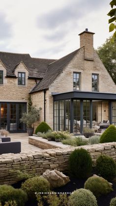 a large stone house with an outdoor seating area