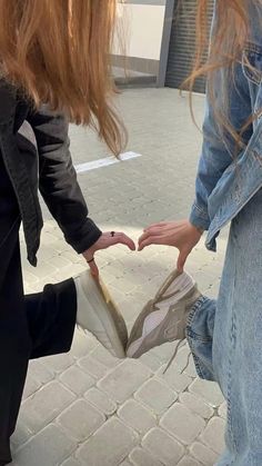 two girls are holding onto each other's shoes