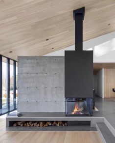 an open fireplace in the middle of a living room