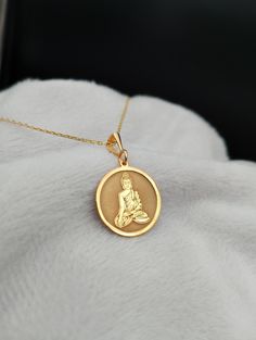 Elevate your style with our exquisite 14K Gold Buddha Necklace, a meticulously handmade masterpiece that seamlessly blends spirituality and elegance. This dainty and intricate religious charm necklace serves as a timeless symbol of peace and tranquility, making it the perfect accessory for those seeking a touch of Zen in their everyday lives. Embrace the serenity of our Yoga Necklace, thoughtfully designed to bring a sense of balance and mindfulness to your wardrobe. ⭐ Package included: One Handmade Necklace ⭐ Pendant Sizes: 14 / 16 / 18 / 20 / 22 / 24 / 26 / 28 / 30 mm ⭐ Necklace Length: 14 / 16 / 18 / 20 / 22 inches ⭐ Materials: 925 Sterling Silver / Gold Plated / 14K Solid Gold Frequently asked questions: ✈️ Express and Free Shipping with UPS. 📦 Items will be shipped within 1-2 busines 14k Gold Spiritual Necklaces For Meditation, Handmade 14k Gold Spiritual Necklace, Spiritual Round Gold-plated Necklaces, Spiritual Round Necklaces For Meditation, Handmade Spiritual Yellow Gold Necklaces, Spiritual Medallion Necklace For Wedding, Spiritual Wedding Necklace With Coin Pendant, Spiritual Wedding Coin Pendant Necklace, Spiritual Round Pendant Necklaces For Wedding