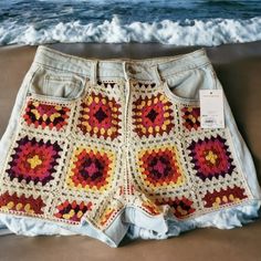 a crocheted shorts is sitting on the beach