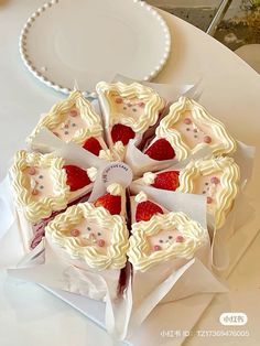 there is a cake with strawberries in the shape of hearts on top of it