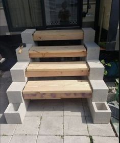 the steps are made out of concrete blocks and have been placed in front of a window