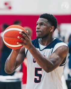 a man holding a basketball in his right hand