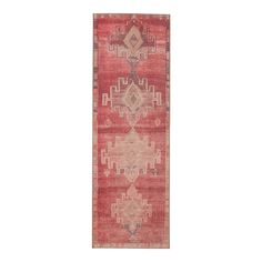 a red rug with an intricate design on the front and back side, in two different colors