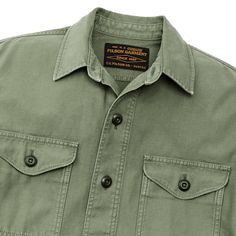 This versatile overshirt provides an added layer of protection on cool days in the field. Patterned after our original iconic Jac-Shirt that’s been a favorite since the 1970s, its versatility makes a sure go-to favorite. The strong midweight fabric is a reverse-sateen weave, smooth on the inside for easy layering. Sturdy buttons secure the front, chest-pocket flaps, and adjustable cuffs. Straight hem for untucked wear. Spread collar. | Filson Field Jac-shirt - WshdFtgGrn Size Large Green Long Sleeve Tops With Flap Pockets, Collared Tops With Patch Pockets For Outdoor, Outdoor Button-up Camp Shirt With Pockets, Outdoor Button-up Tops With Patch Pockets, Utility Style Tops With Pockets For Outdoor, Utility Tops With Pockets For Outdoor, Button-up Tops With Patch Pockets For Outdoor, Khaki Collared Camp Shirt For Outdoors, Cotton Military Tops For Outdoor Activities