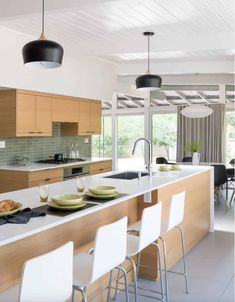 the kitchen is clean and ready to be used for dinner or lunchtime, while the dining table has been set up