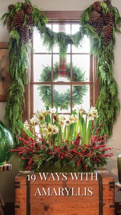 christmas wreaths and greenery decorate the window sill in front of an old trunk