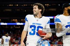 two detroit lions football players walking off the field after their game against the new york giants