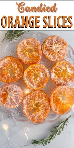 candied orange slices on a glass platter with rosemary sprigs and text overlay