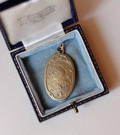 Step back in time with this charming antique pendant from the Art Nouveau/Jugendstil era (c. 1890s-1910s). This beautiful oval silver-plated pendant features a detailed raised relief of a woman's profile. Her hairstyle and clothing hint at a Victorian influence, with her hair gracefully pulled back and adorned with delicate floral elements. Encircling the portrait is a flowing, decorative border with intricate floral motifs and natural curves--hallmarks of the Art Nouveau style, which celebrated nature and the beauty of the human form. The back of the pendant also features a decorative pattern, making it lovely from every angle. This pendant is a true testament to the exquisite craftsmanship of the era and would make a perfect addition for anyone who admires the Art Nouveau design. Conditi Art Nouveau Silver Filigree Necklace, Art Nouveau Locket, Handmade Art Nouveau Pendant Necklace, Art Nouveau Sterling Silver Pendant, Art Nouveau Pendant With Vintage Charm, Design Art Nouveau, Art Nouveau Silver, Female Profile, Antique Pendant