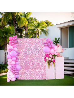 a pink and white birthday party with balloons