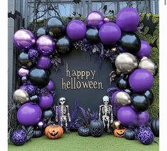 a purple and black halloween decoration with balloons