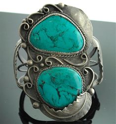 "Talk about a statement look! This vintage sterling silver and turquoise cuff bracelet is big and bold and fabulous. Two substantial sized turquoise stones are set in scalloped bezels with rope, swirl, & leaf details. What a wonderful to your jewelry collection. Sterling Silver Turquoise Cuff Bracelet Vintage Bracelet is 3 1/4\" inches wide by 2 1/4\" inches across Weighs 69.6 Grams Please read through our policies prior to purchase. Thank you for looking!" Lacy Clothes, Turquoise Jewelry Native American, Southwest Jewelry, Navajo Jewelry, Turquoise Bracelet Cuff, Native American Turquoise, American Turquoise, Jewelry Turquoise, Coral Jewelry