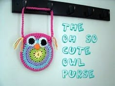 a crocheted owl purse hanging on a hook with the words, the owl cutie owl purse